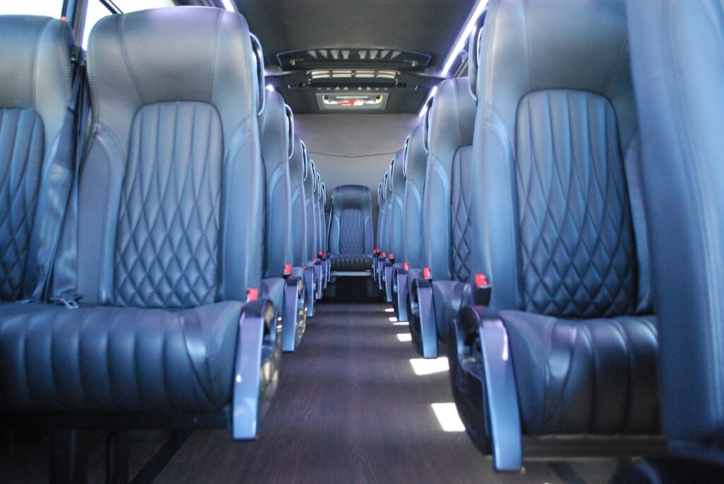 interior of a las vegas mini coach rental; view down the aisle with rows of comfortable seats