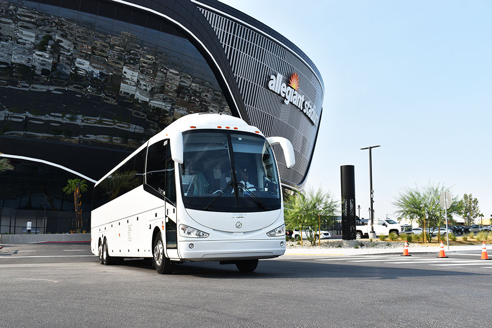 White Charter Bus Parked in Front of Allegiant Stadium in Las Vegas