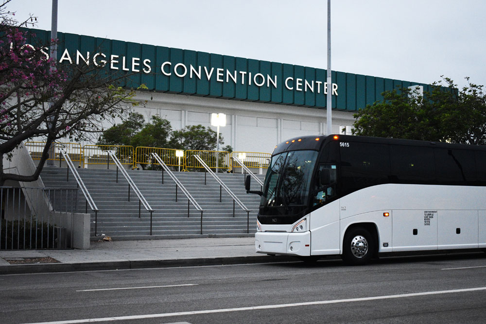 photos of a white charter bus from TLC Luxury Transportation parked outside of the Los Angeles Convention Center