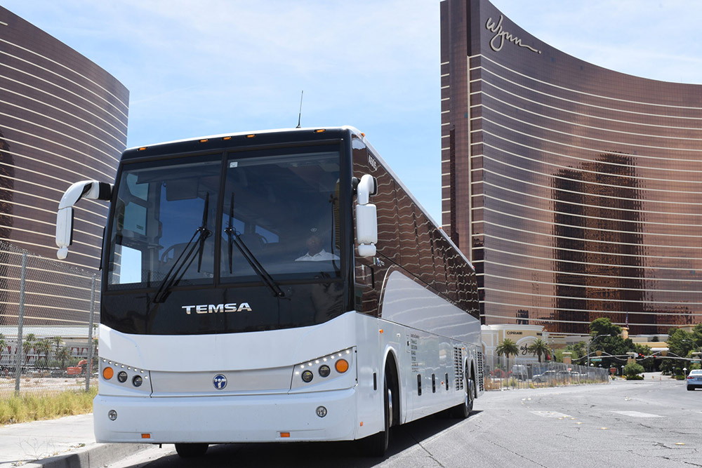 one of TLC Luxury Transportation's white Temsa charter buses parked outside the Wynn in Las Vegas