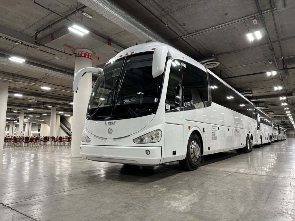 White charter bus rental parked inside warehouse